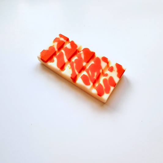 Rectangular wax melt bar with red and white pattern on a white background
